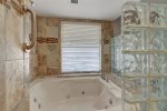 Updated master jetted tub with shower and glass block privacy